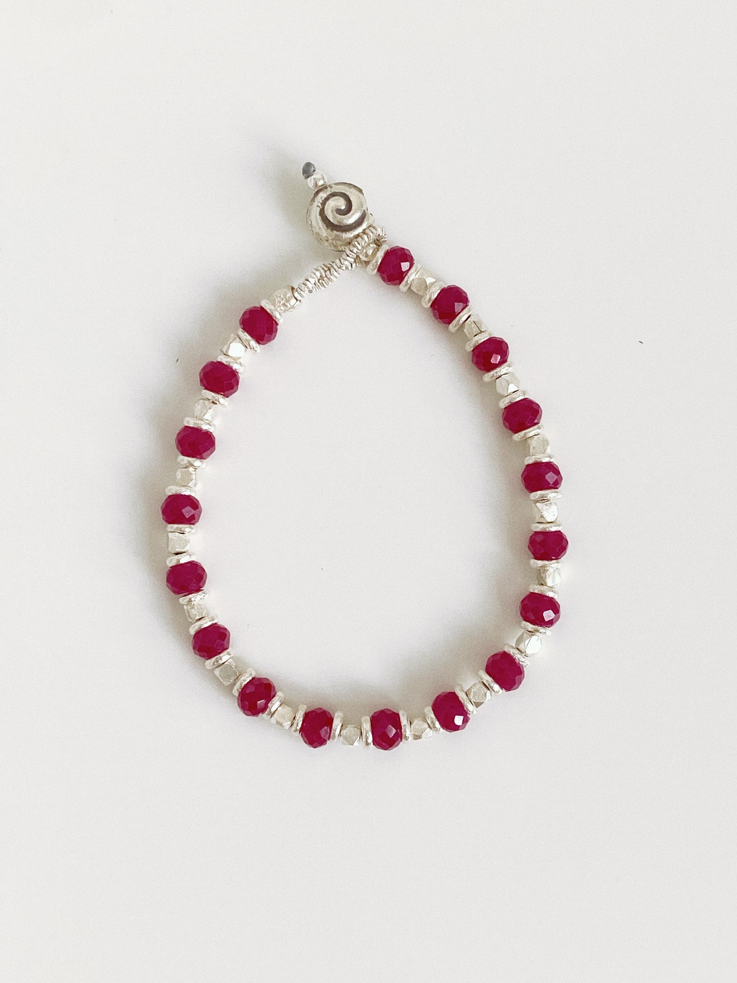 Berry handmade red corundum bracelet, faceted berry red beads between silver cubes with a spiral button clasp.
