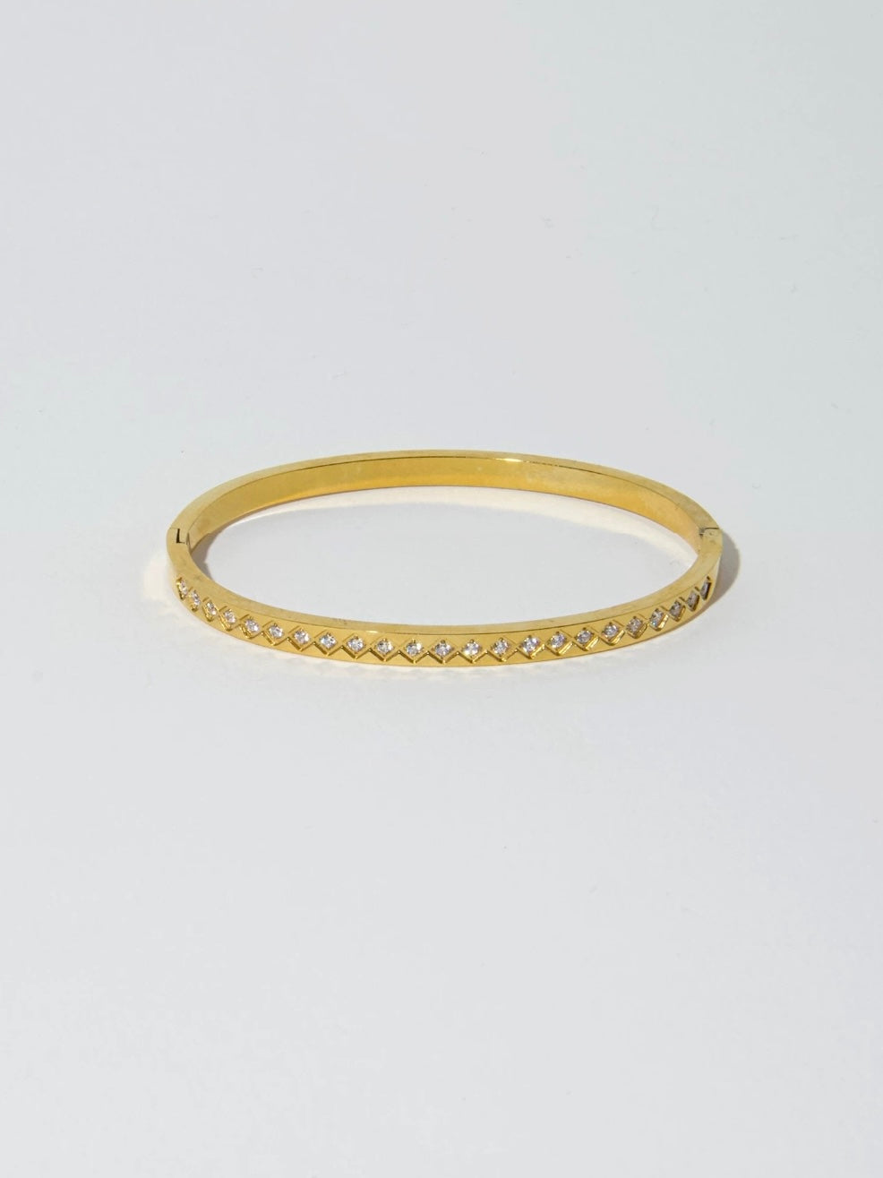 Single view of the waterproof gold stainless steel bangle with a repeating rhombus trellis texture.