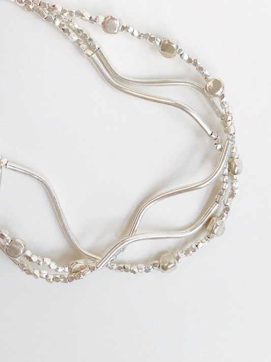 Ripple triple-layer 925 sterling silver bracelet showing wavy bar, faceted beads and disc chain detail by Deja Vu Jewellery
