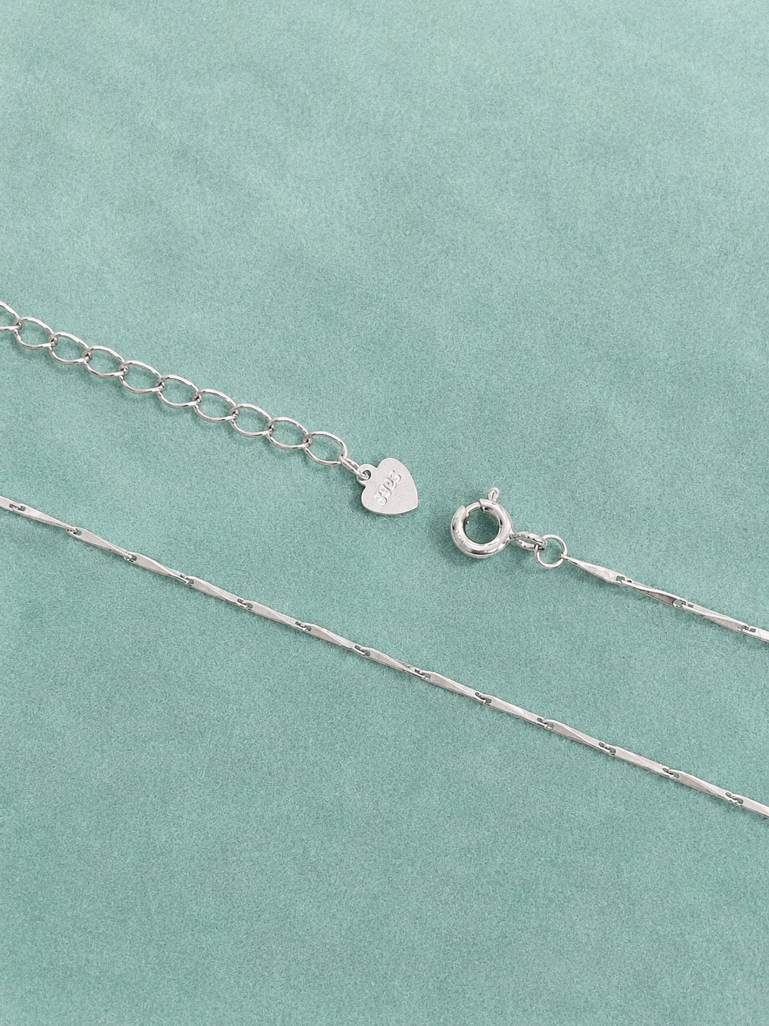 Spring ring clasp, extender chain and small heart 925 tag on a fine sterling silver bar chain necklace