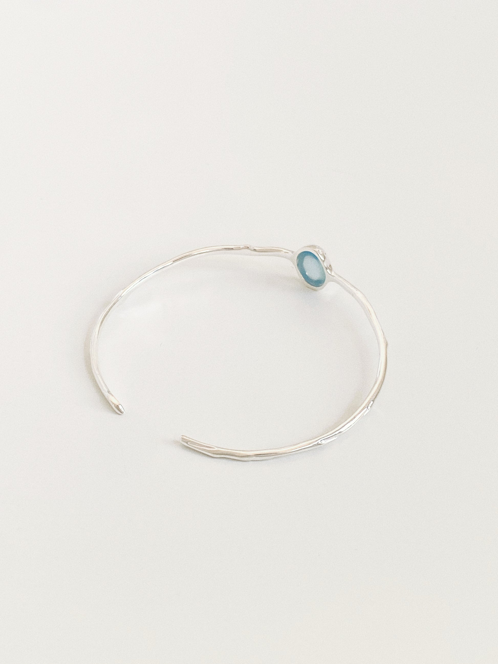 Rivage silver cuff bangle showing the open back design and irregular hammered band texture