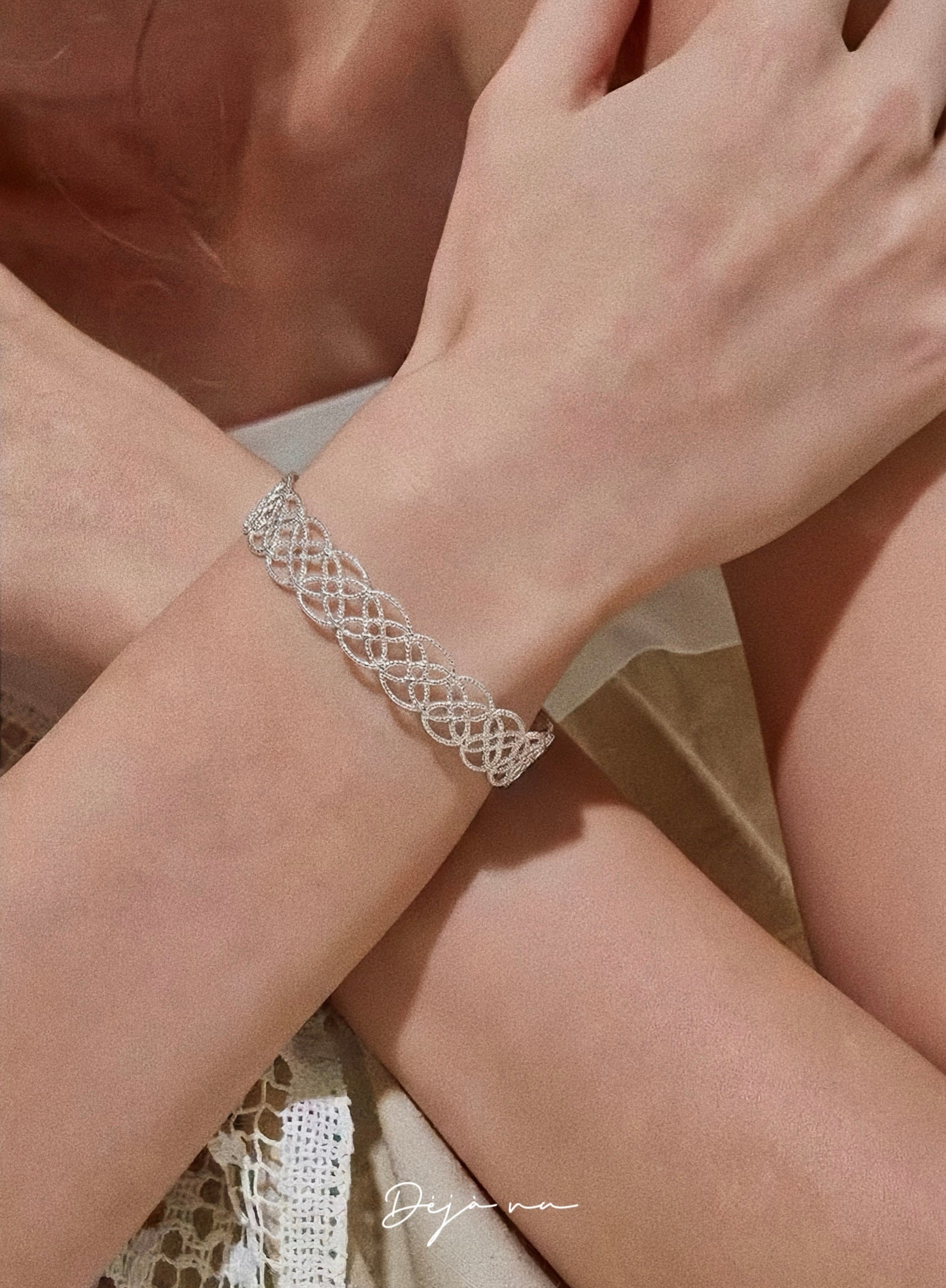A model showcasing the silver Arabesque Petal Lace Cuff, demonstrating its elegant 9mm width and fit.