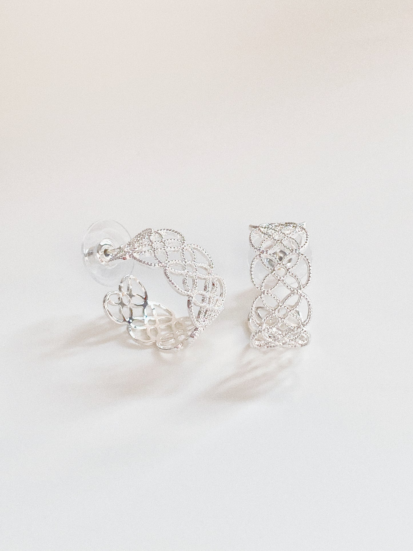 Detailed view of the silver lace hoops showing the high-quality color retention plating.