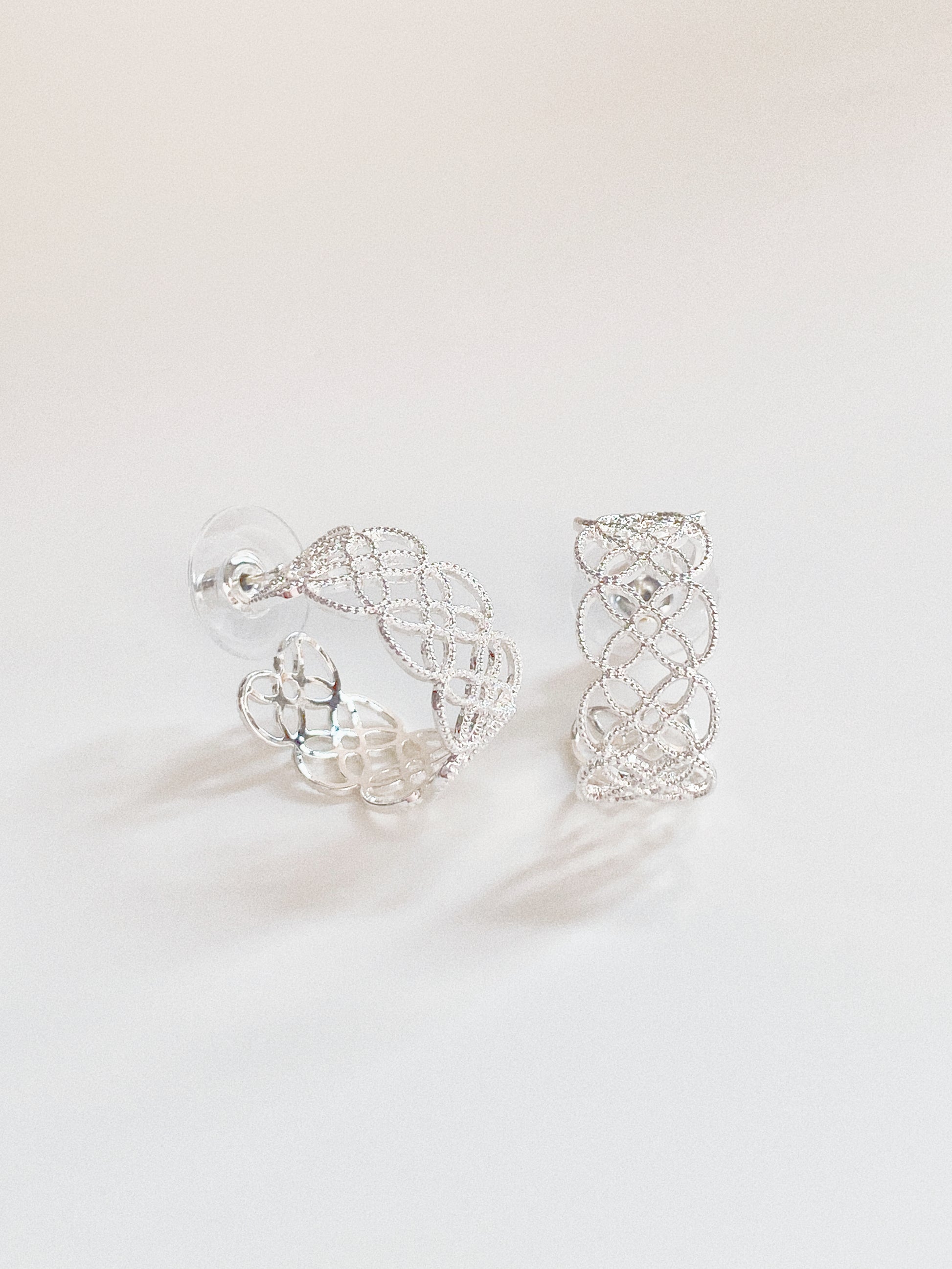 Detailed view of the silver lace hoops showing the high-quality color retention plating.