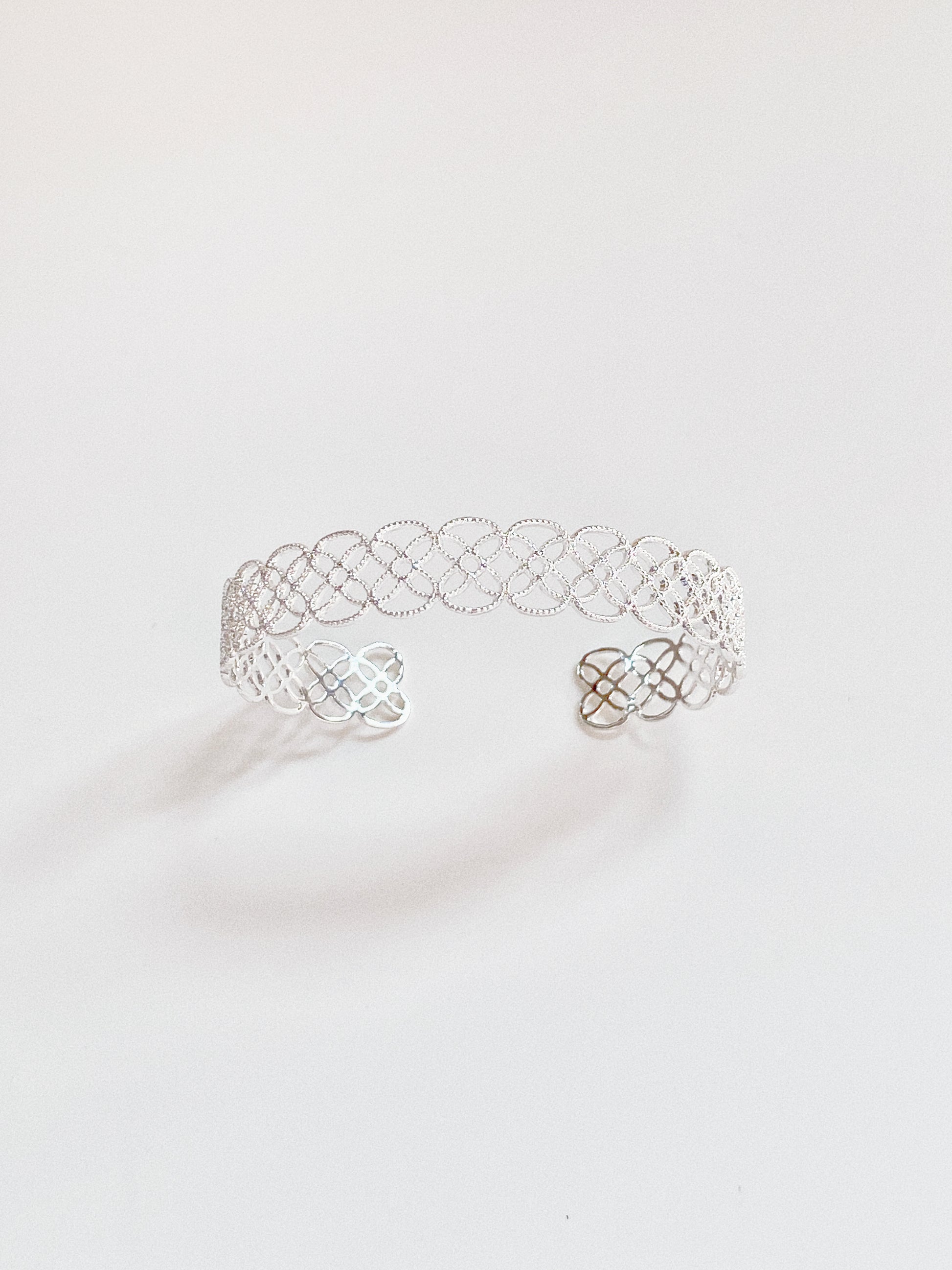 The sterling silver version of the Arabesque Petal Lace Cuff, highlighting its crisp, modern shine.