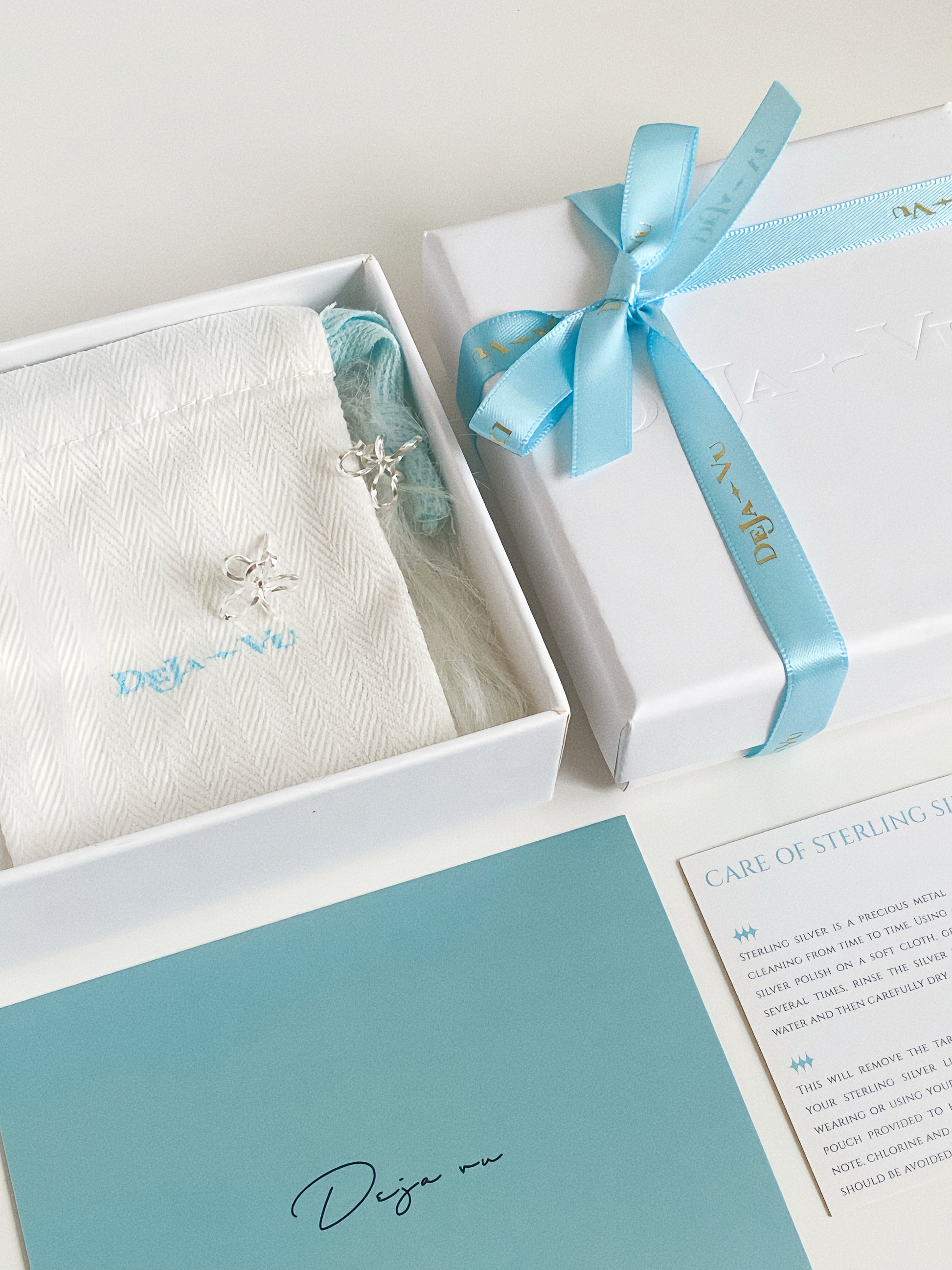 Wire flower stud earrings presented inside Deja Vu Jewellery gift box with polish cloth, ribbon and sterling silver care card