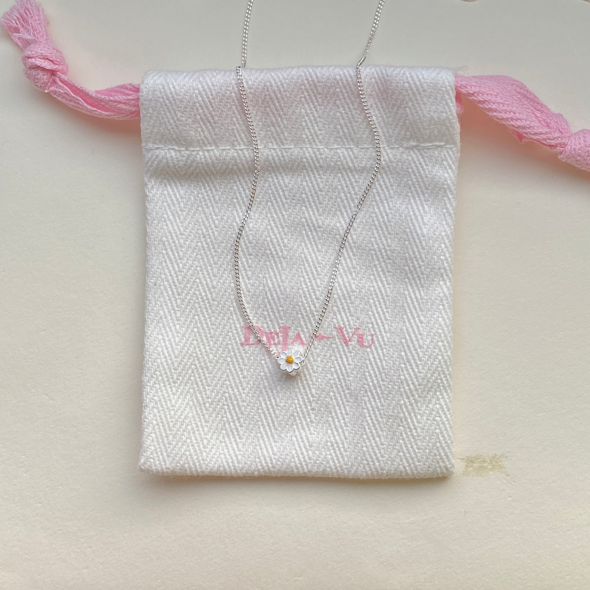 Sterling-silver daisy pendant necklace laid flat, 40–45 cm adjustable