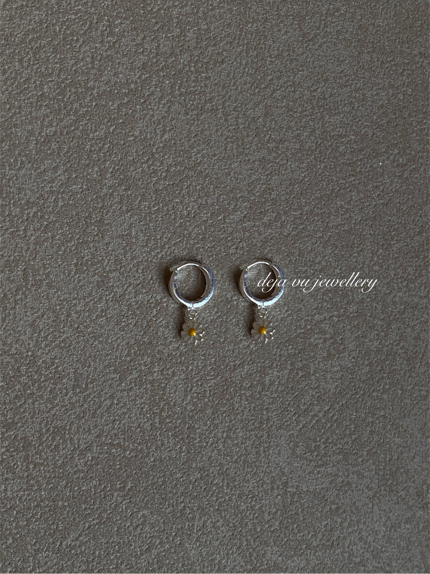 Pair of small sterling-silver huggie hoops with double-sided enamel daisy drops