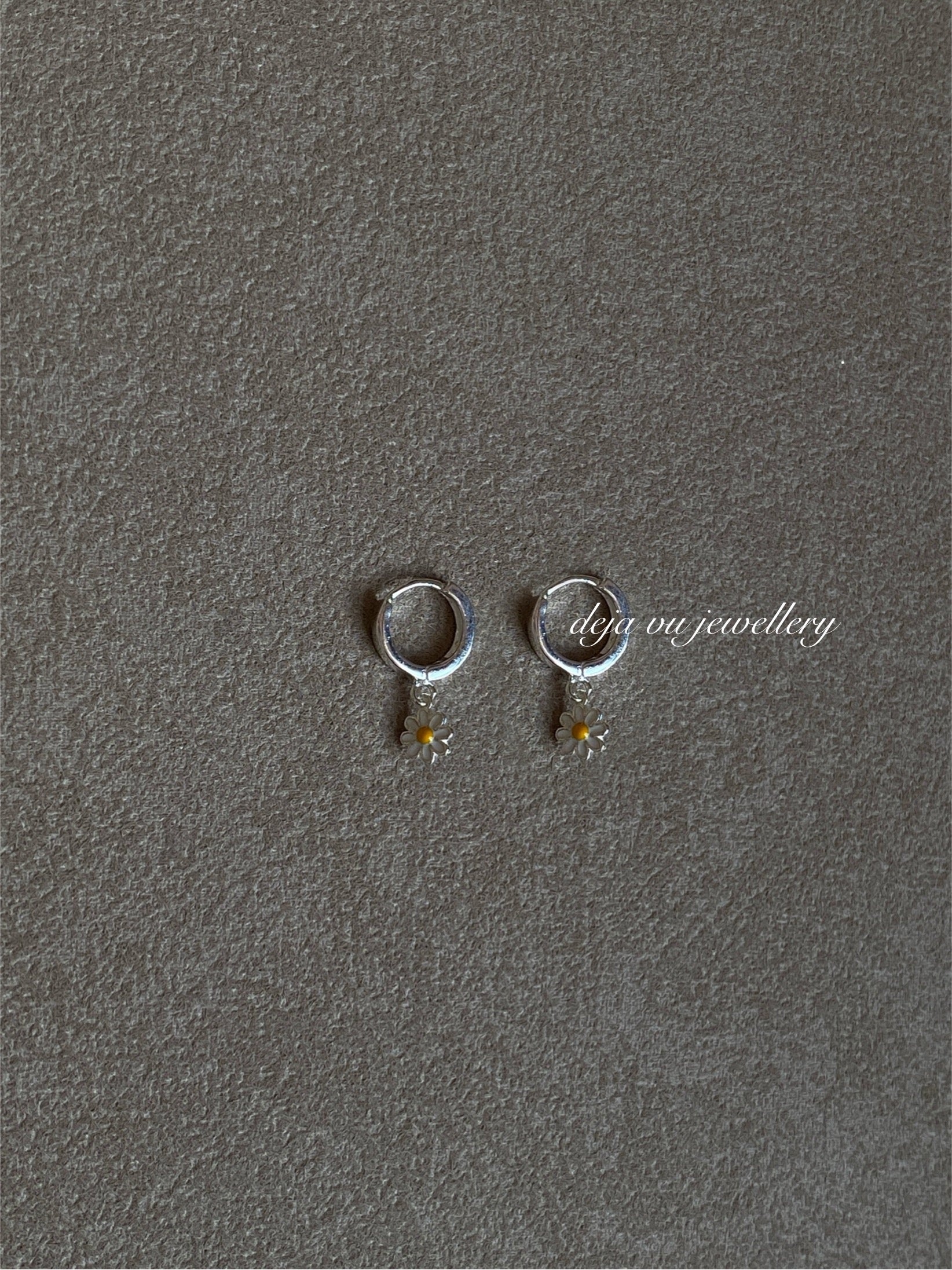 Pair of small sterling-silver huggie hoops with double-sided enamel daisy drops