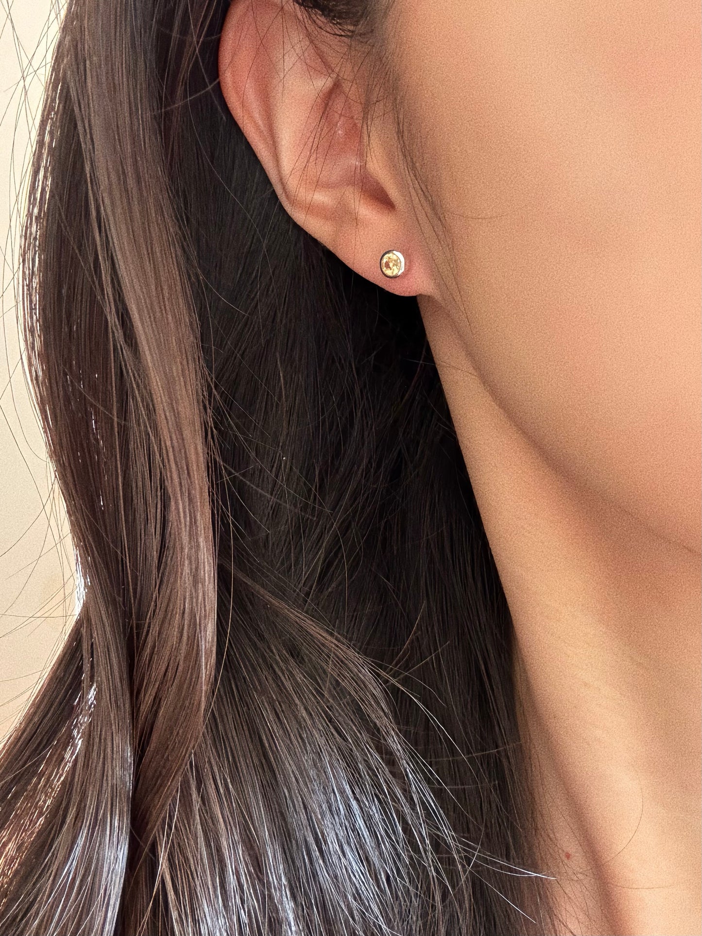 Close up of the faceted citrine bubble stud on the earlobe, showing the dainty 5-6mm size perfect for daily wear.