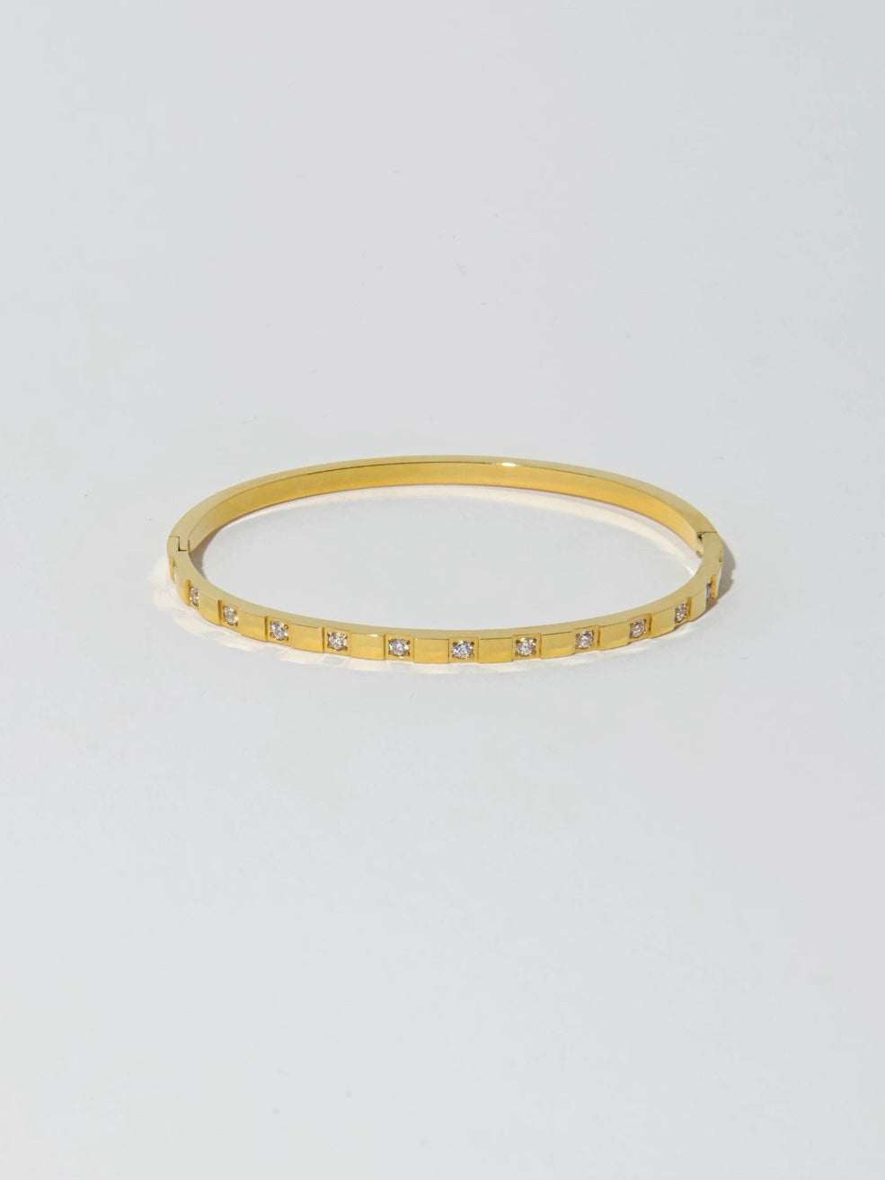 Single view of the gold tarnish-free stainless steel bangle with a clean square grid pattern.