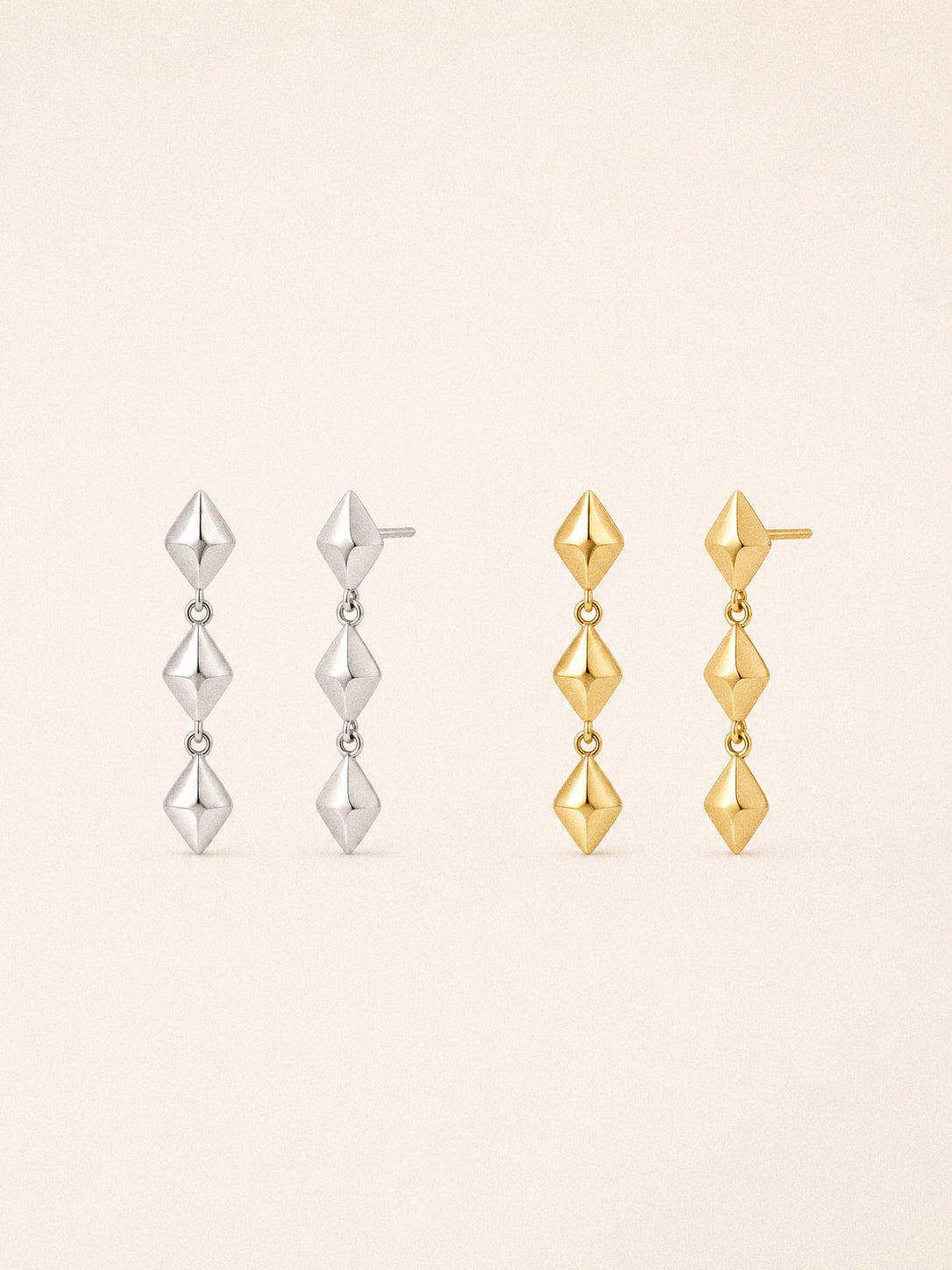 Vega star drop earrings in 18k gold plated and sterling silver, three faceted stars linked in a line.