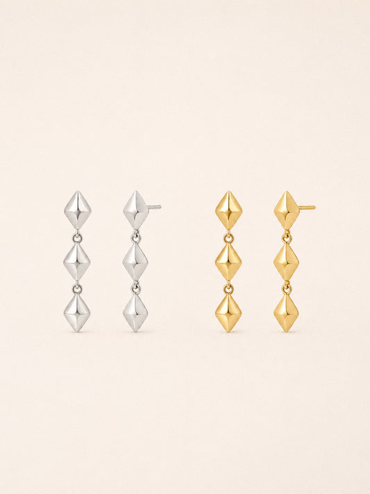 Vega star drop earrings in 18k gold plated and sterling silver, three faceted stars linked in a line.