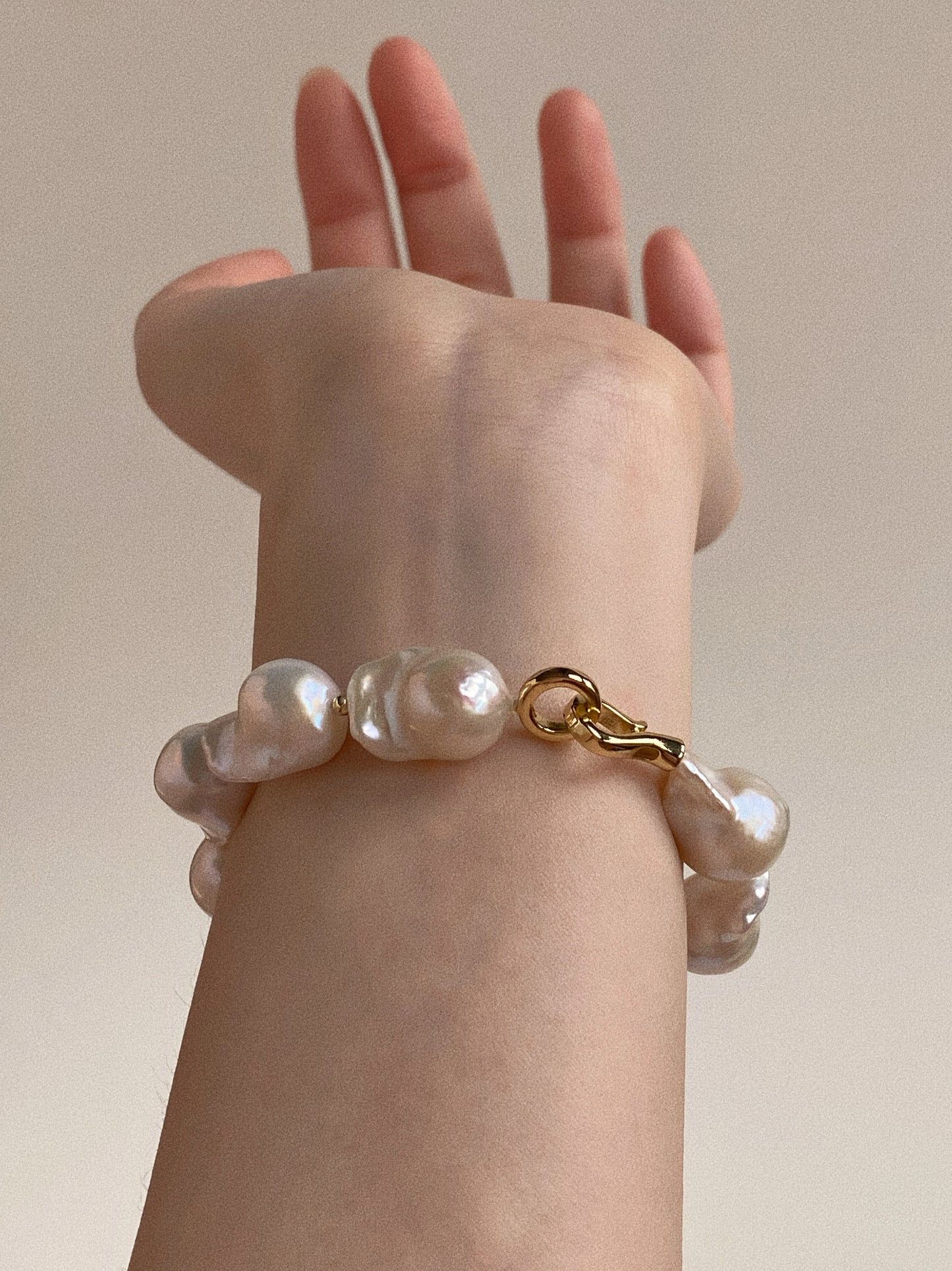 Wrist shot of the chunky freshwater pearl bracelet showing the substantial volume and organic texture.