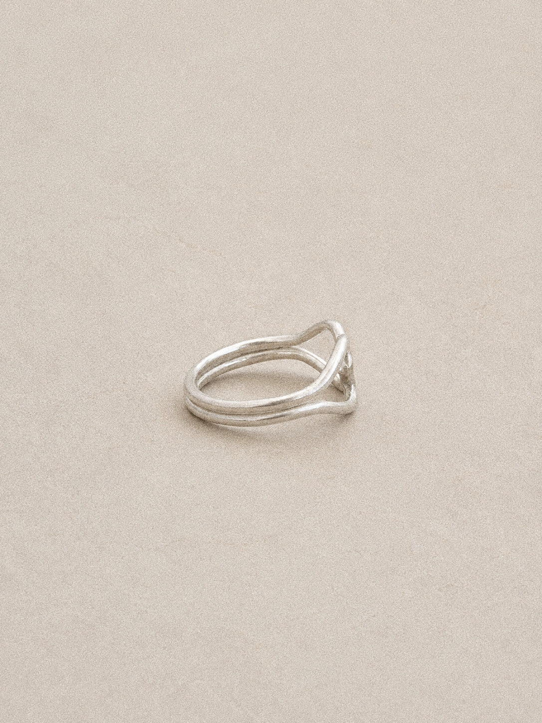 Side view of the double heart ring showing its twin 925 silver bands flowing into each heart.