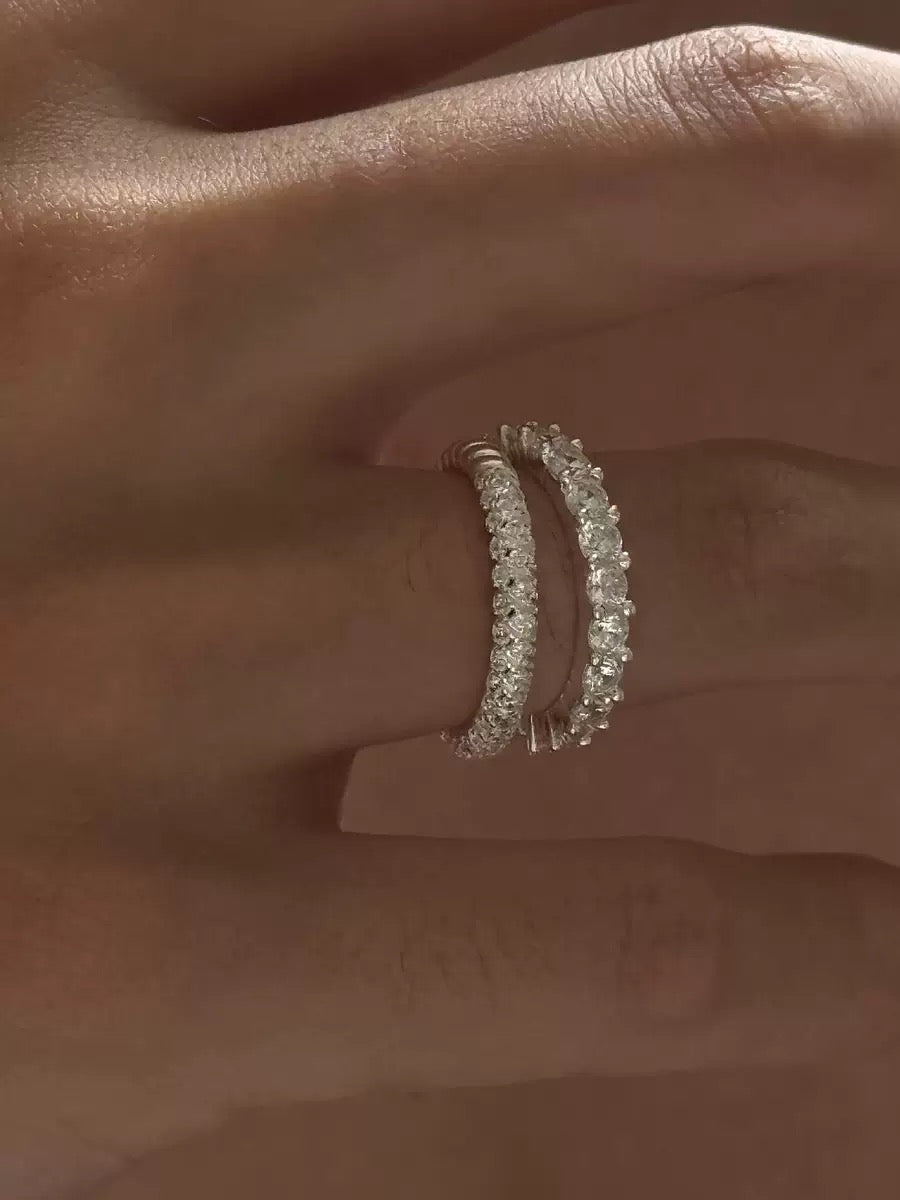 Two slim pavé silver eternity bands stacked on one finger, low-profile and smooth for everyday wear.
