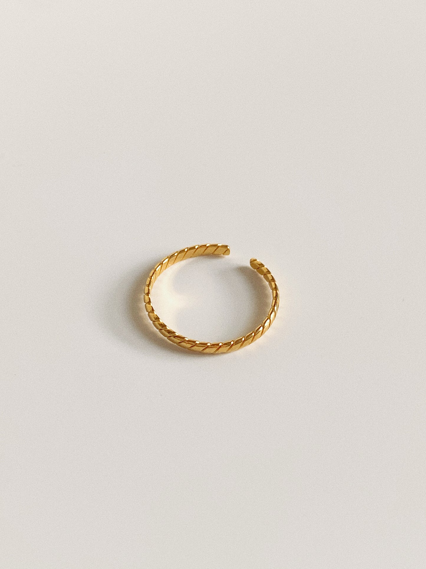 A narrow version of the gold twisted stripe ring, 100% waterproof and tarnish-free.
