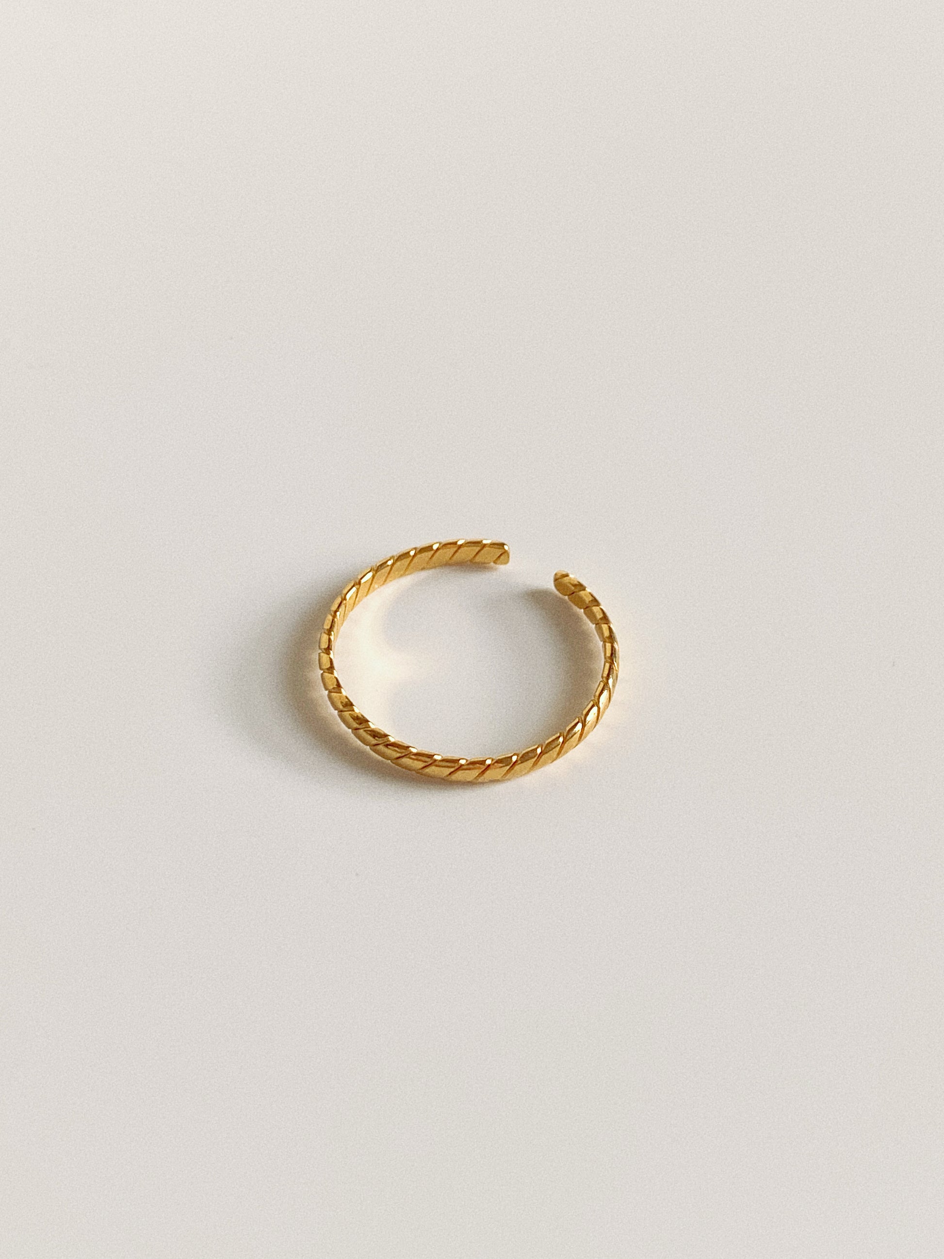 A narrow version of the gold twisted stripe ring, 100% waterproof and tarnish-free.