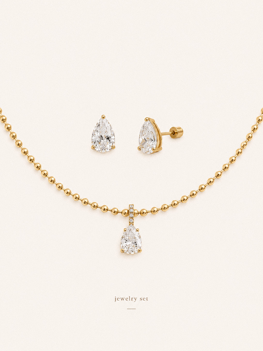 Dew teardrop jewellery set with pear cut cz stud earrings and matching pendant necklace in 18k gold