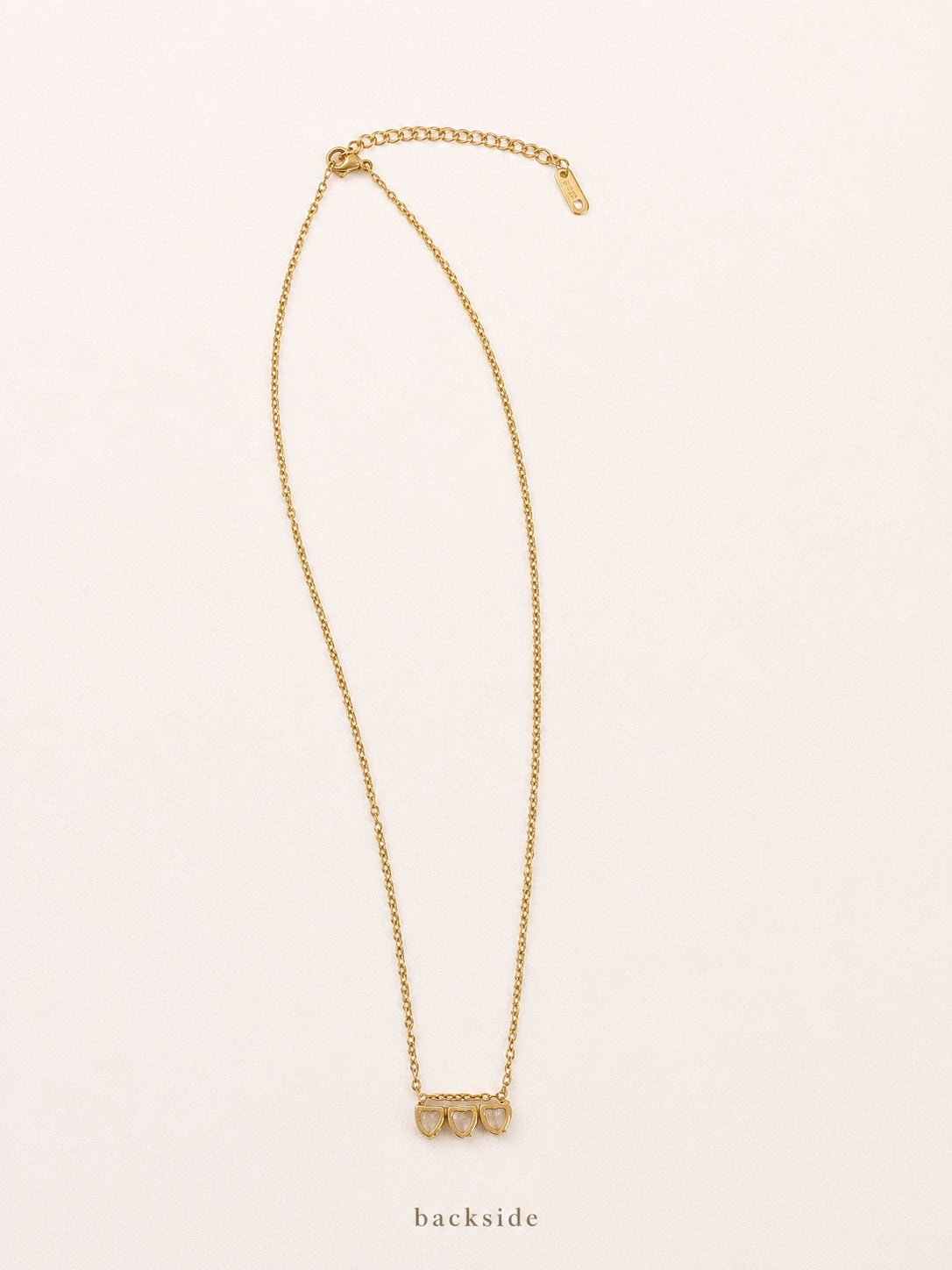 Full view of the Trio heart necklace showing the 42cm chain, 5cm extender and setting from the back