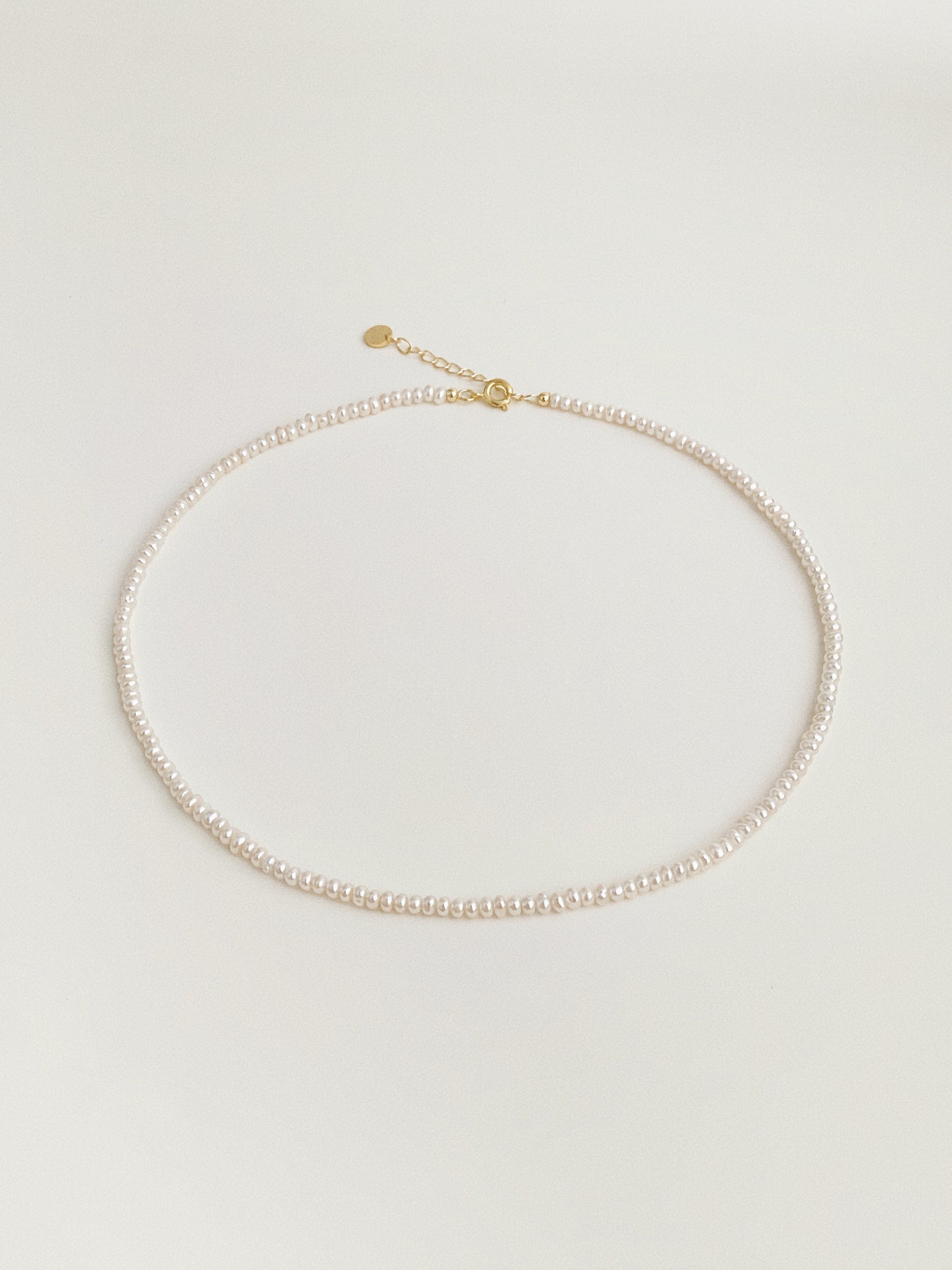Tiny freshwater pearl choker necklace with gold spring clasp and extension chain by Deja Vu Jewellery