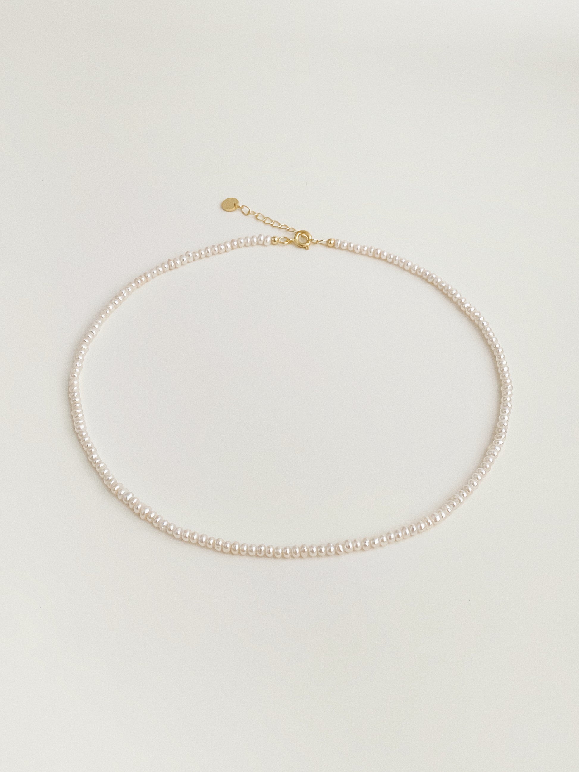 Tiny freshwater pearl choker necklace with gold spring clasp and extension chain by Deja Vu Jewellery
