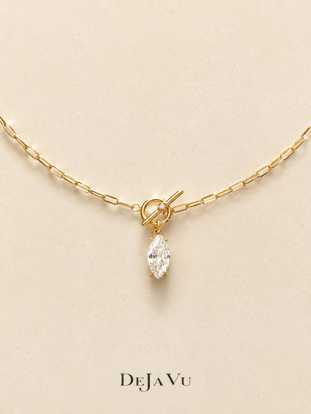 Gold paperclip chain necklace with a front toggle clasp and marquise cut cubic zirconia drop, waterproof titanium steel by Deja Vu