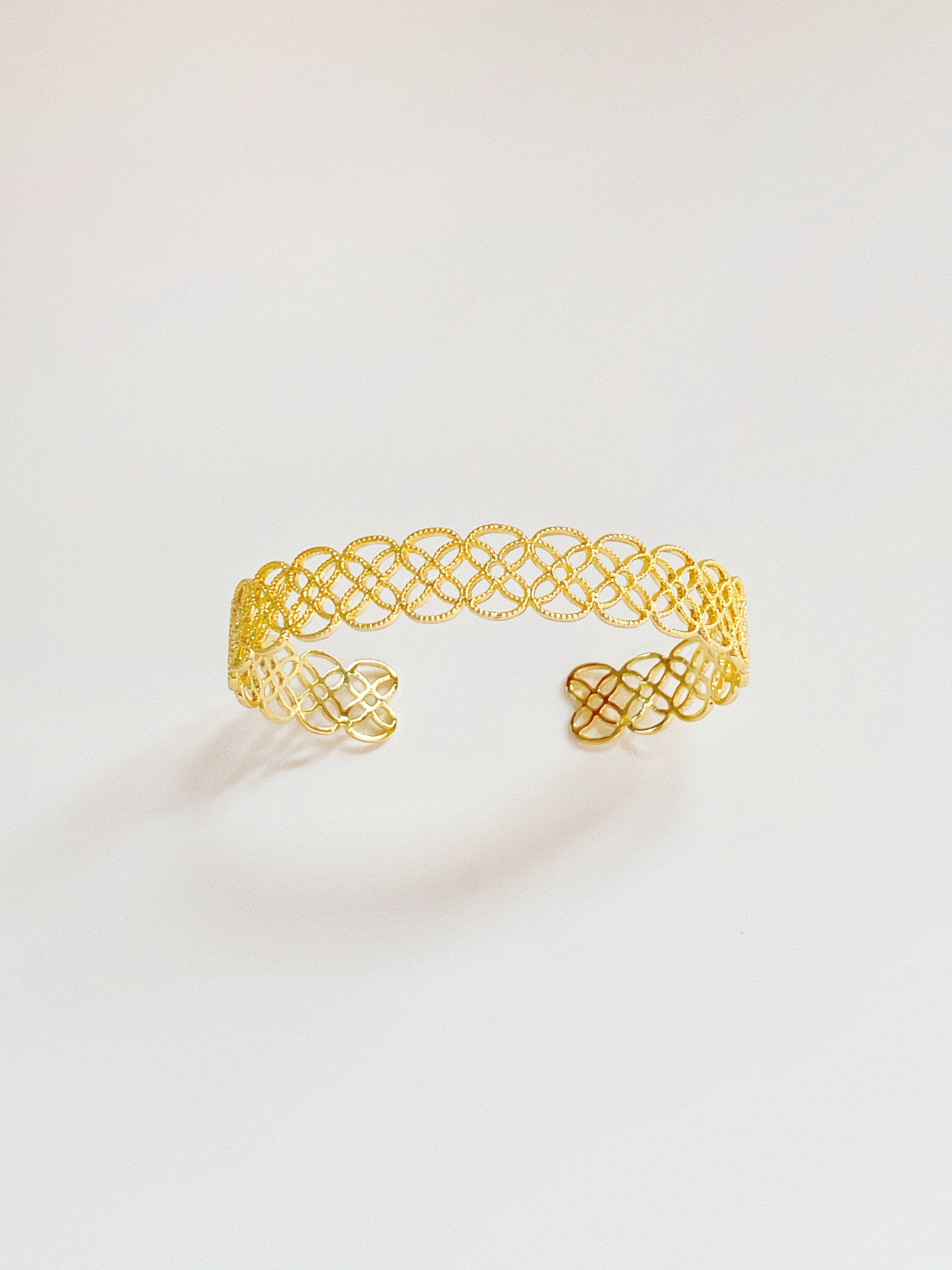 A close-up of the 9mm gold Arabesque Petal Lace Cuff showing the intricate filigree cut-out pattern.