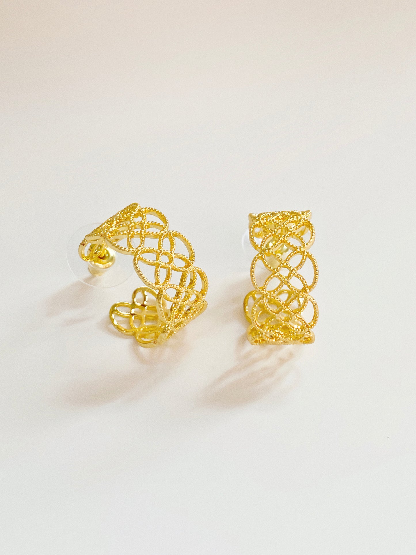 Side view of the gold lace earrings, demonstrating the secure 925 silver post and polished finish.