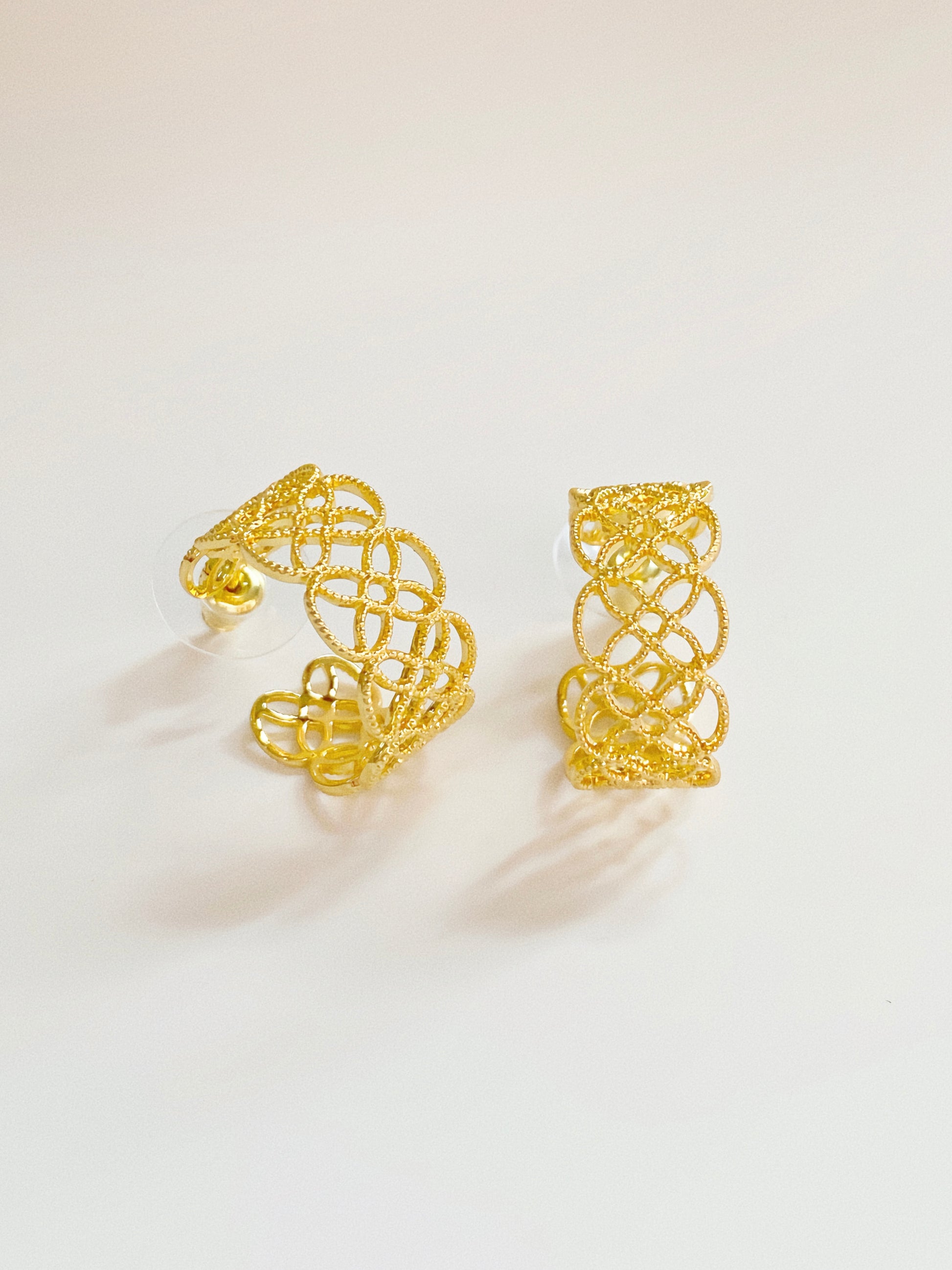 Side view of the gold lace earrings, demonstrating the secure 925 silver post and polished finish.
