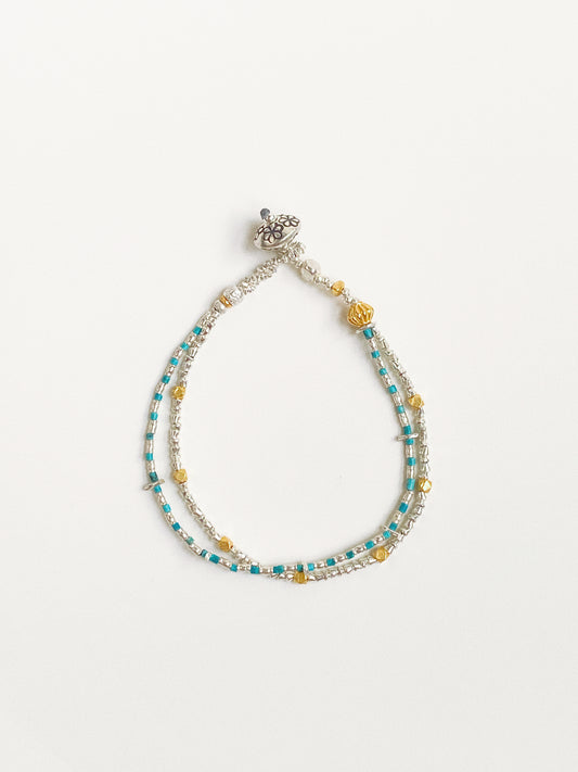 Handmade double-layer turquoise bracelet with Thai silver and 24k gold-plated beads flat lay by Deja Vu Jewellery