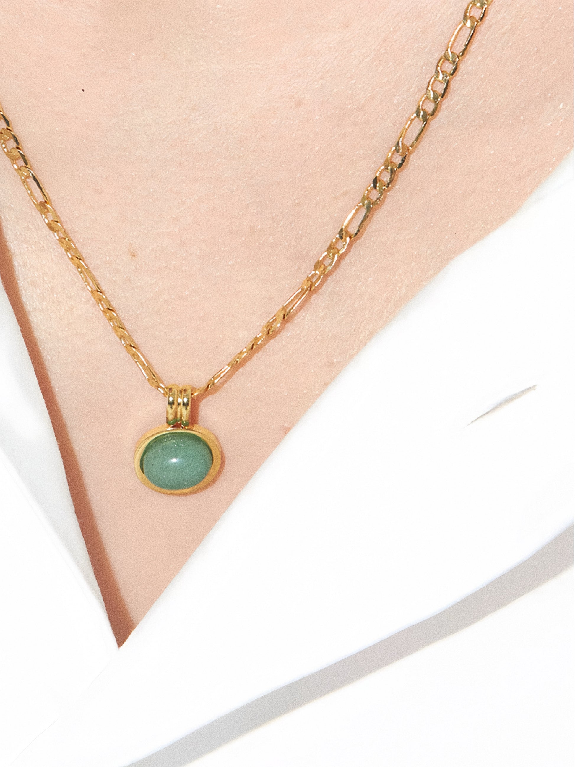 Close-up detail of the 1.2cm aventurine pendant on an 18k gold plated titanium steel chain.