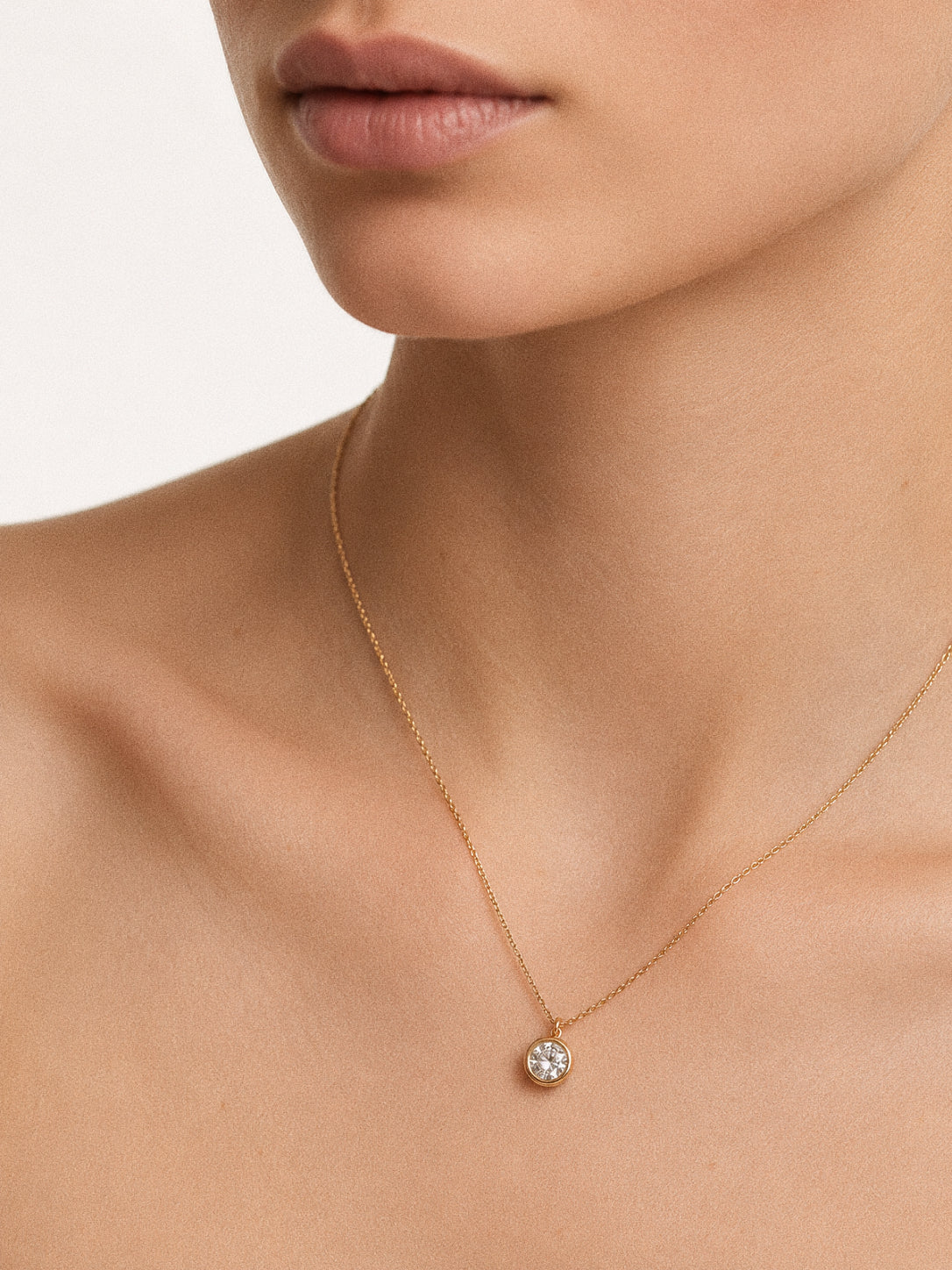 Model wearing the Aura 2 carat waterproof solitaire necklace sitting at the collarbone