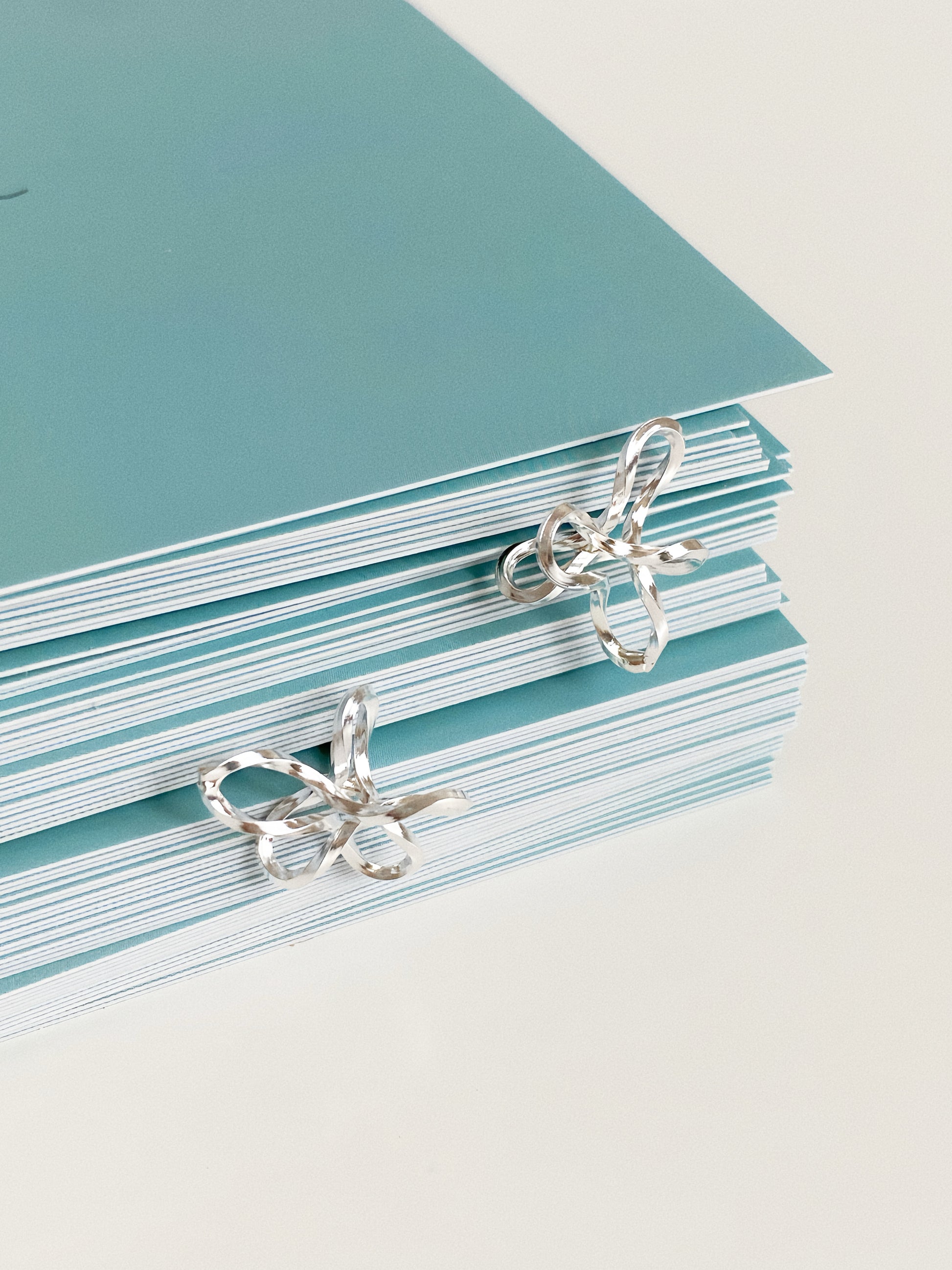 Sterling silver wire flower stud earrings styled on Deja Vu Jewellery branded gift cards
